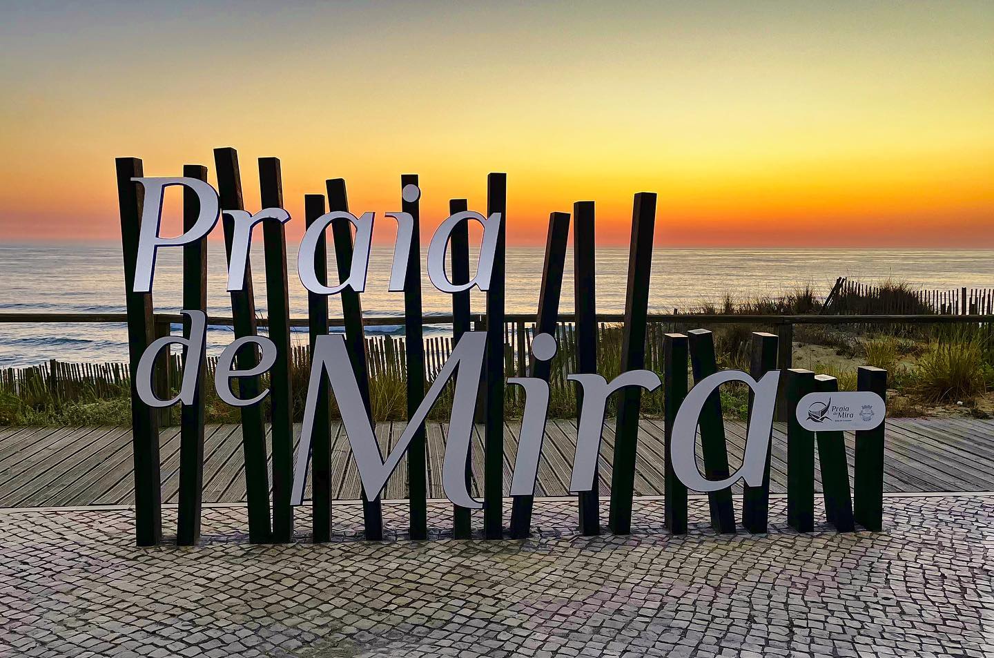 Praia de Mira sign at sunset.
